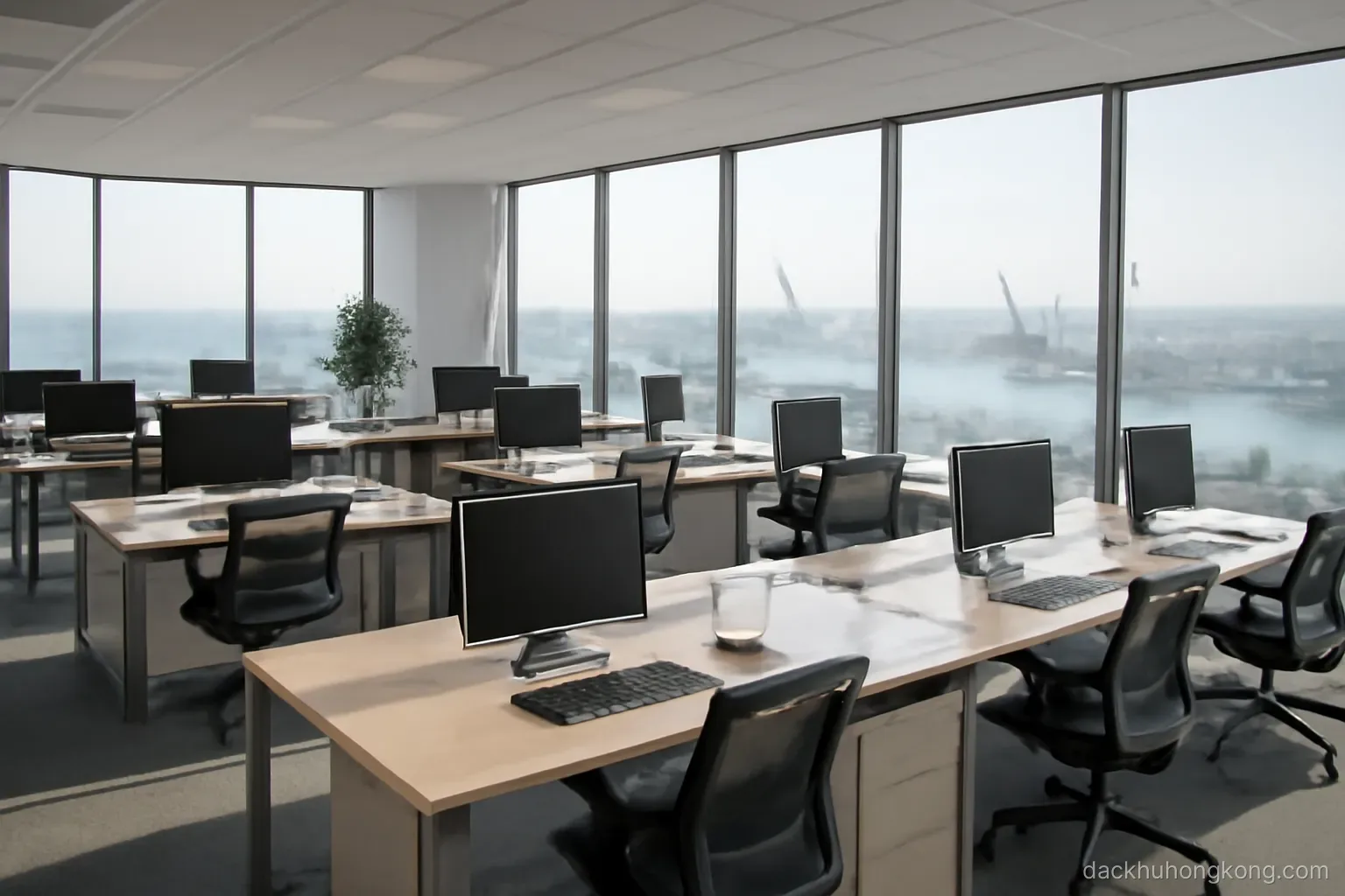 an open-plan office floor high in a tower with wide windows looking down on cranes and water far below